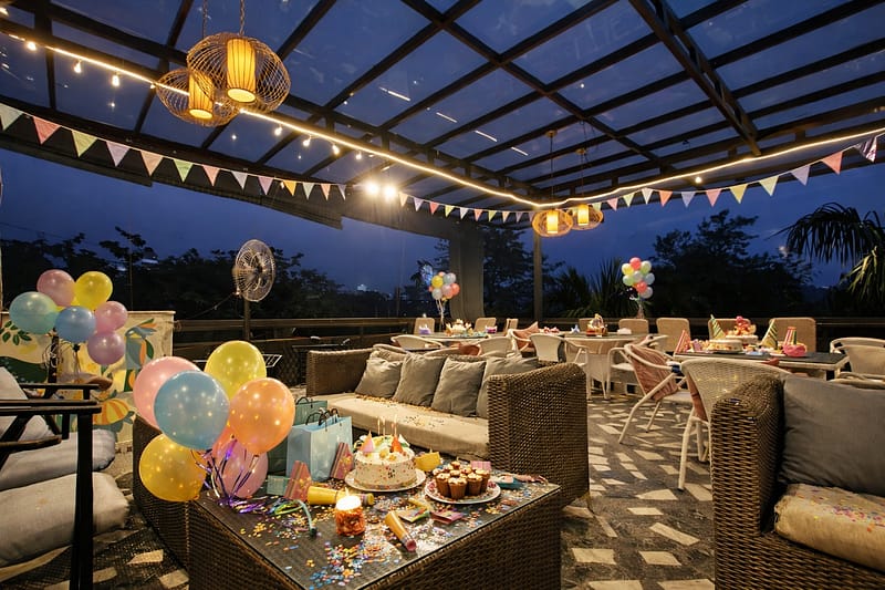 Rooftop birthday party with drinks, music, and city lights